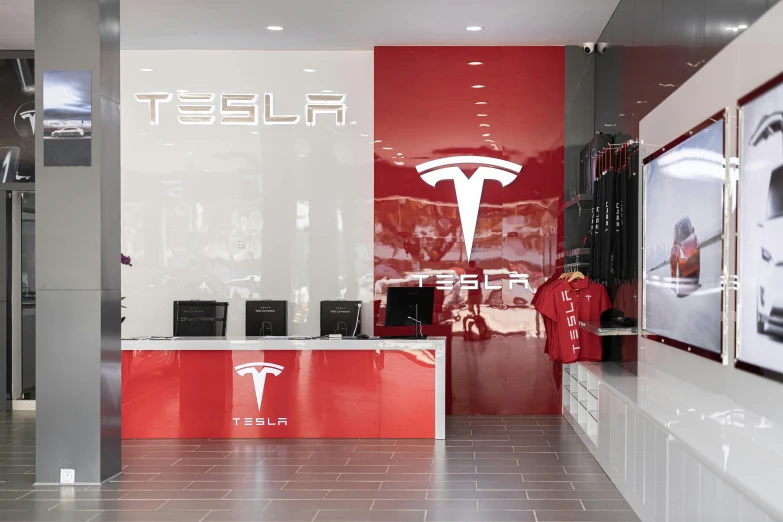 the tesla car showroom is a large and modern place