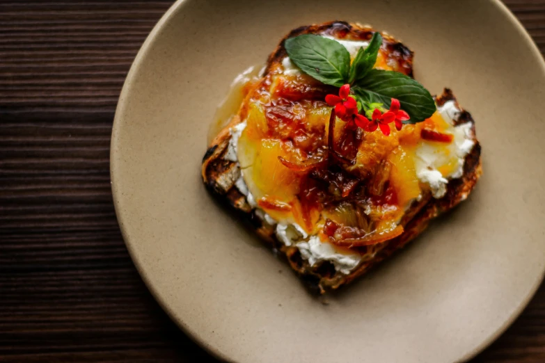 a plate topped with food on top of a wooden table