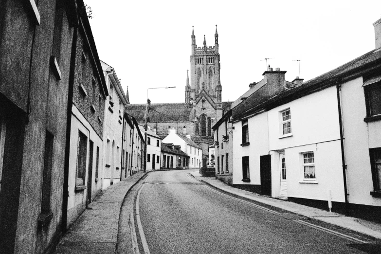 an old european street with church in background