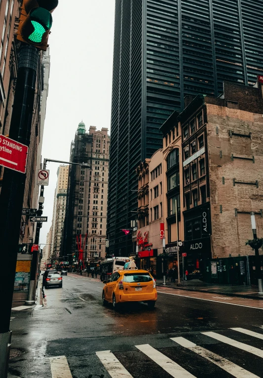 a taxi cab waits for a green light to change colors