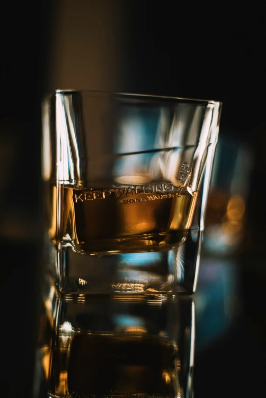 some glass of whiskey sitting on top of a table
