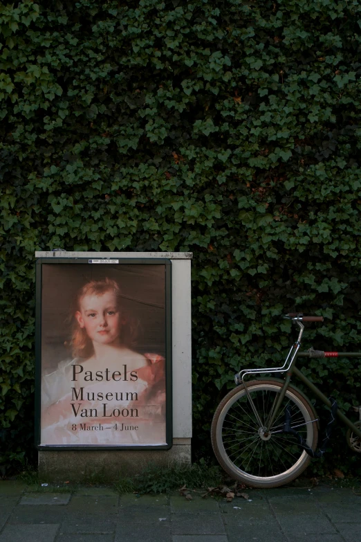 a bicycle parked next to a fake poster