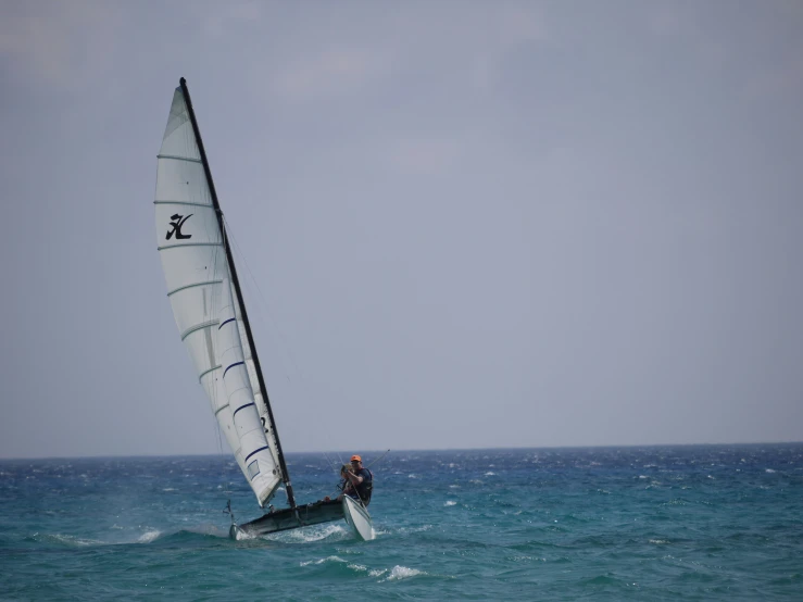 man wind surfing on the top of choppy water