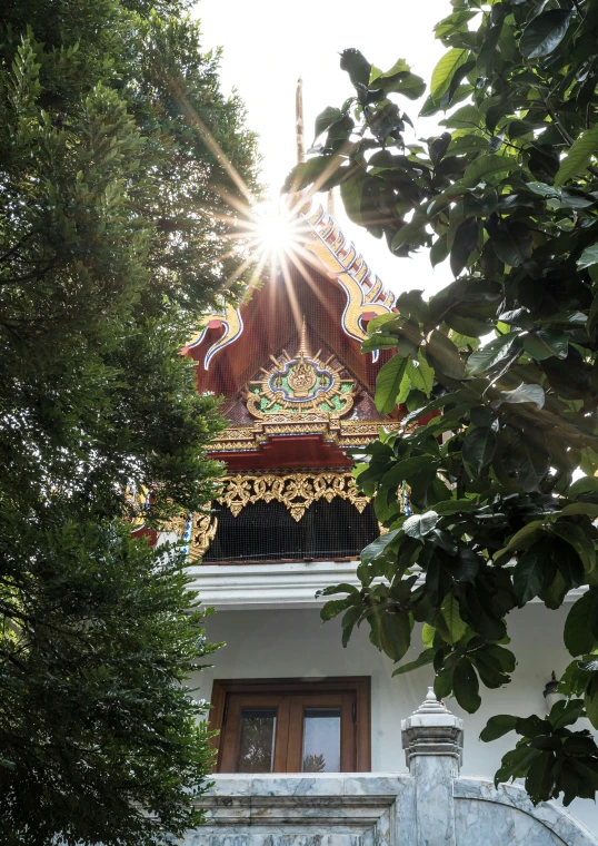 a building with many details and trees surrounding it