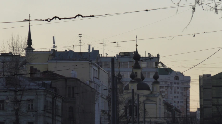 silhouettes of buildings and wires at sunset