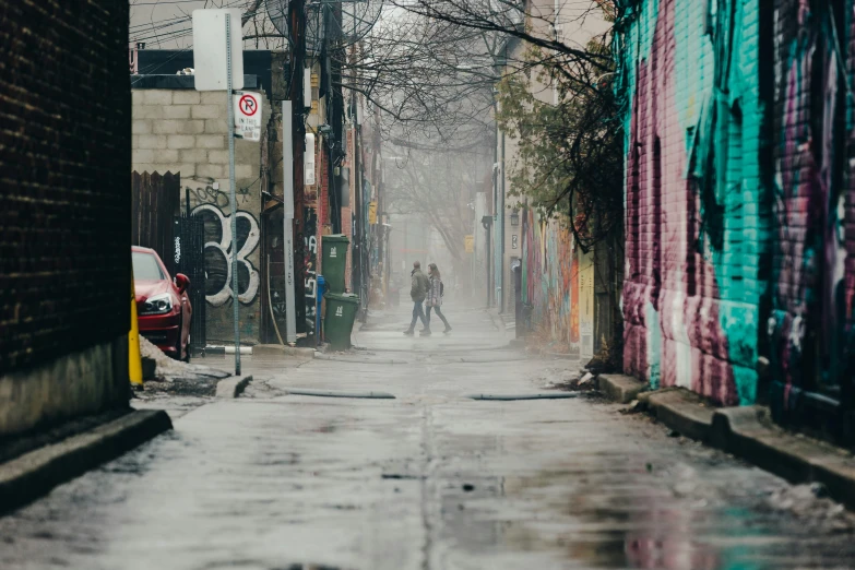 two people walking on a rainy day on an alleyway