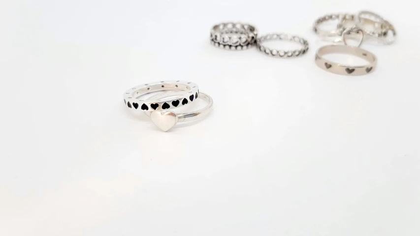 a set of five rings with black diamonds