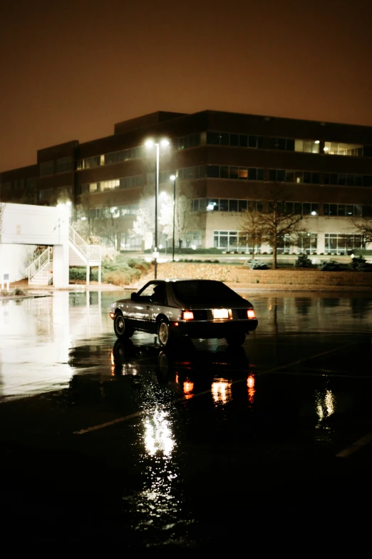 there is a car in the dark by a building