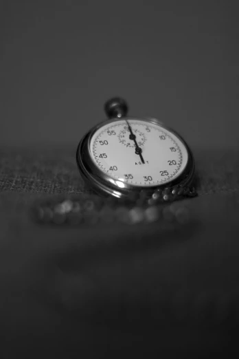 a black and white image of a pocket watch