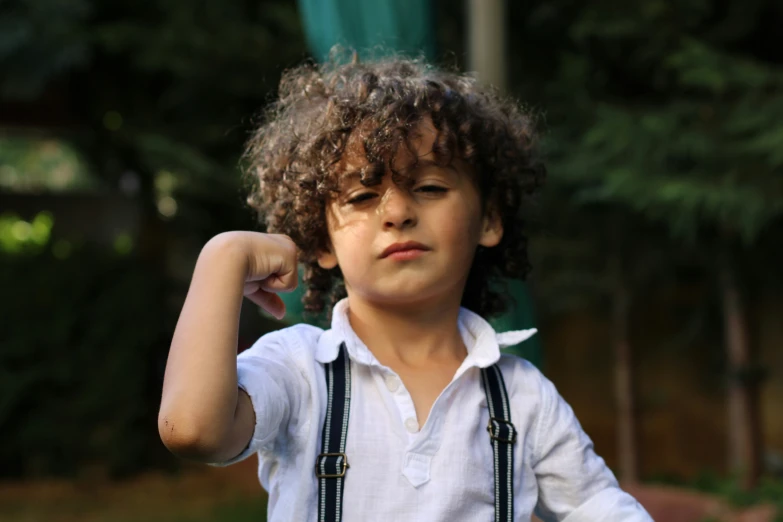 a close up of a child holding his arm