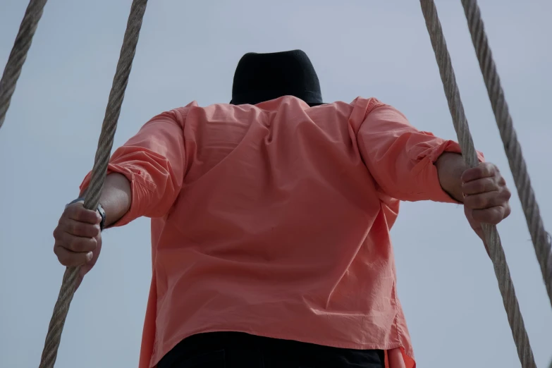 a man is holding onto the ropes of a boat