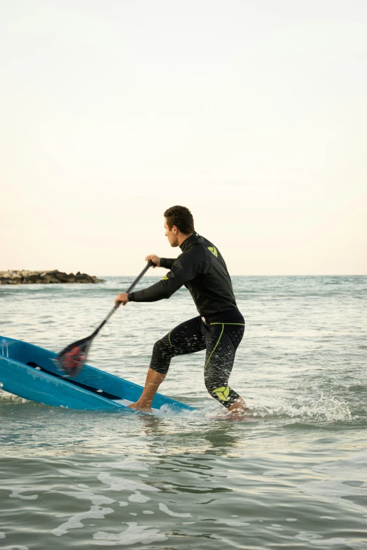 a man that is standing on a surfboard with a paddle