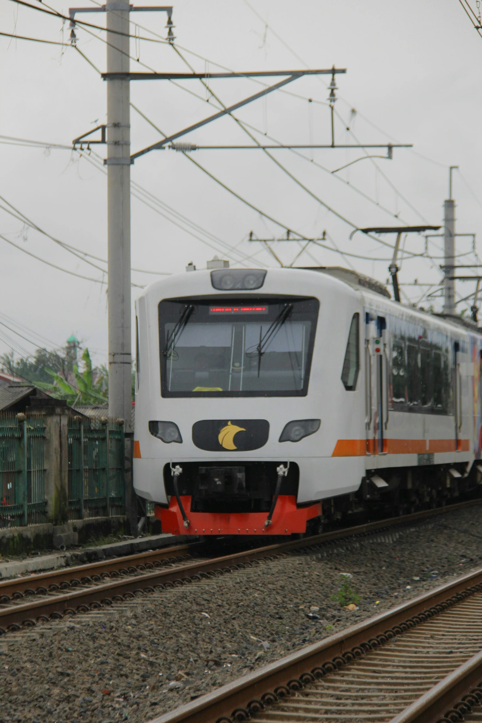 a train traveling on top of tracks next to houses