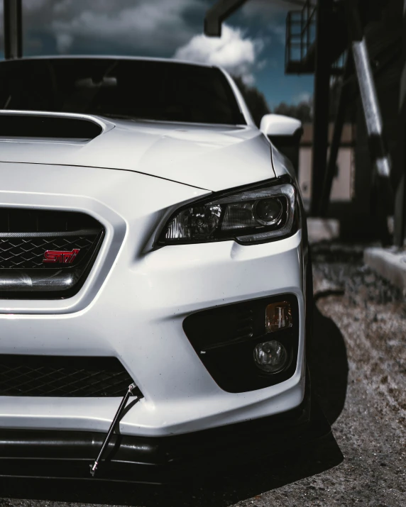 the front bumper of a white sports car