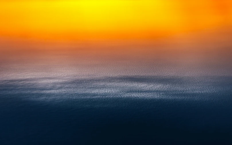 some bright orange yellow water and white clouds