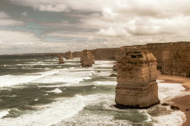 a body of water near cliffs and the beach