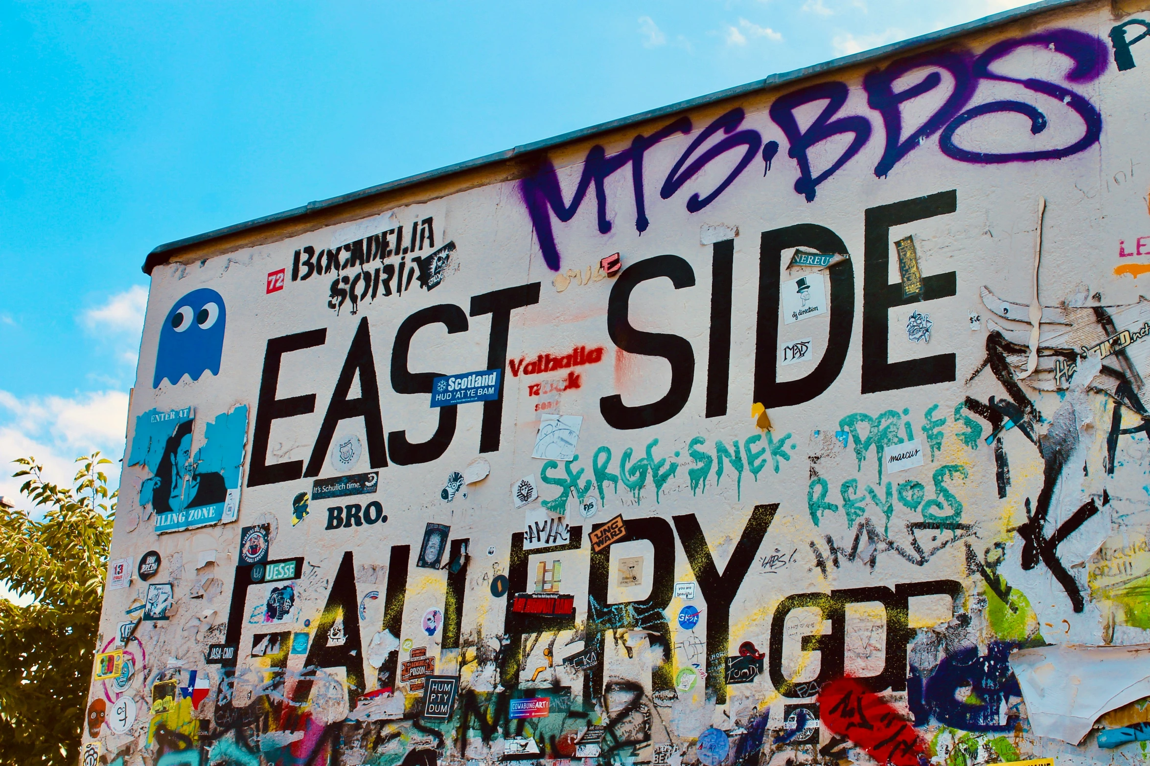 a large sign is covered with graffiti as if it were in a school