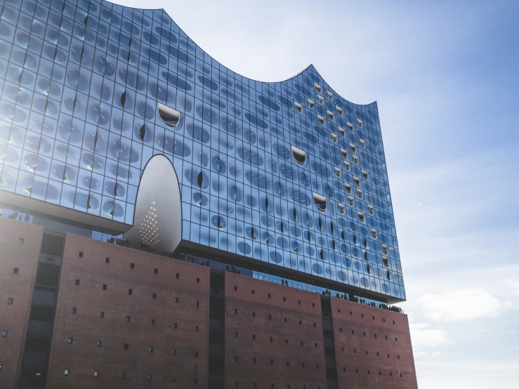 a large glass building on the side of a large red brick wall