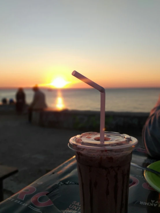 there is a drink that is next to the ocean