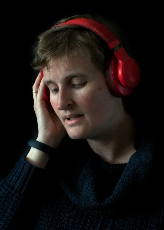 a young man is wearing headphones and listening to music