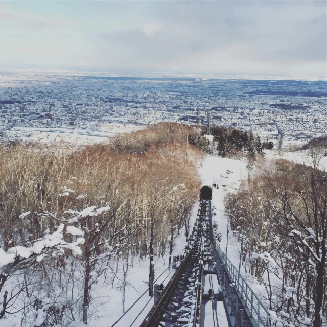 the view from the top of a hill in winter