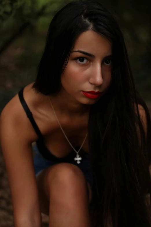 a young woman wearing a black tank top and blue underwear posing for a picture