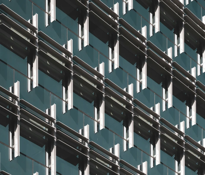 blue and green building with several balconies that have a small airplane in the window