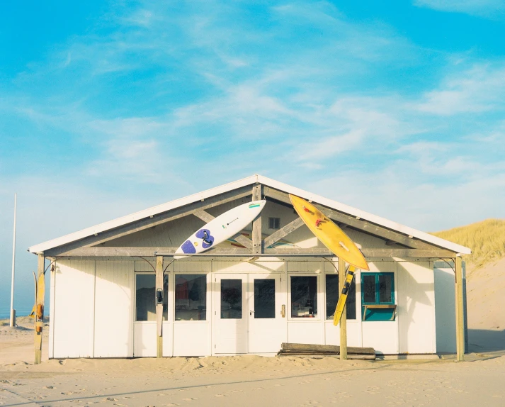 a surfboard is propped up in front of a house