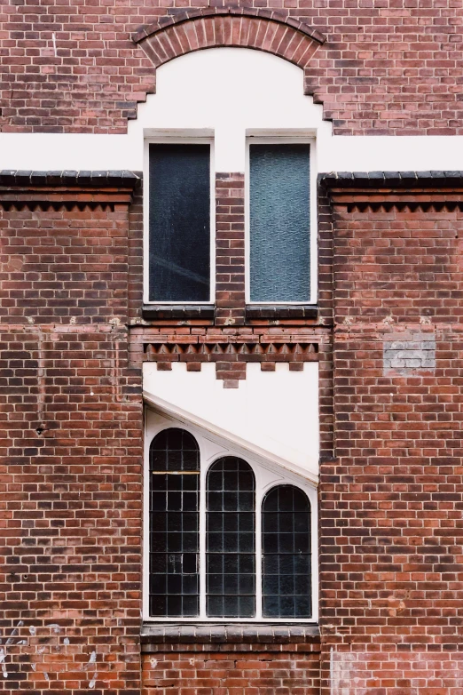 an arched window on the side of a brick building