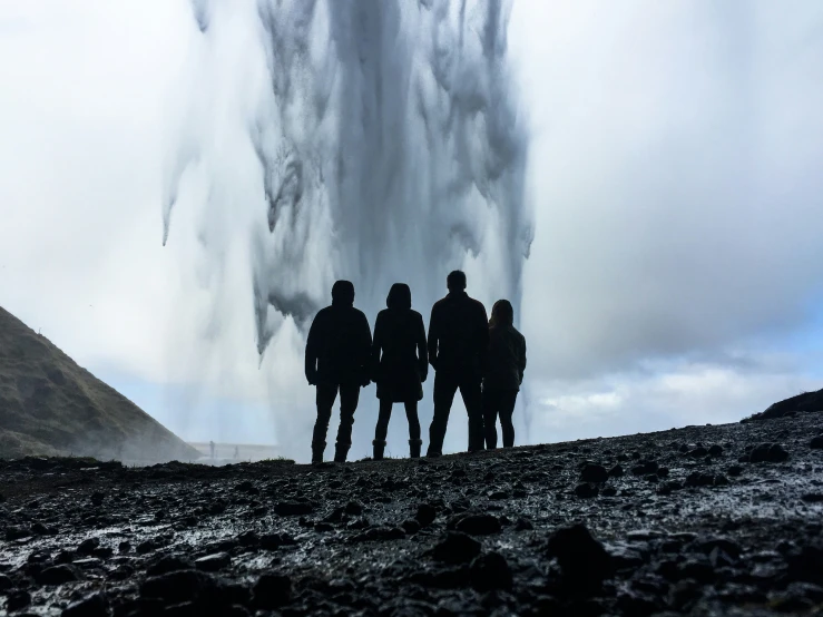 the people are looking at the large waterfall