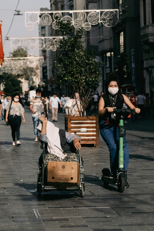 a person on a scooter next to an object with a mask