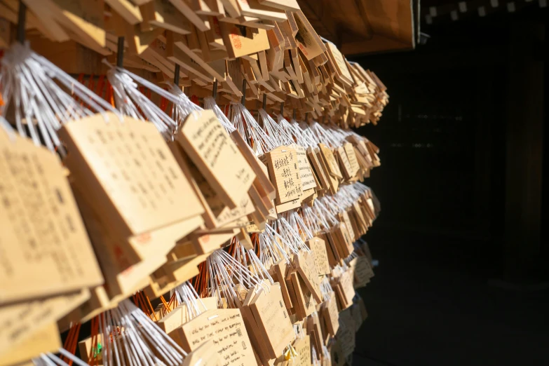 a display wall covered in wooden tags and paper