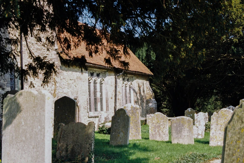 a church and graveyard that appears to be surrounded by tall stones