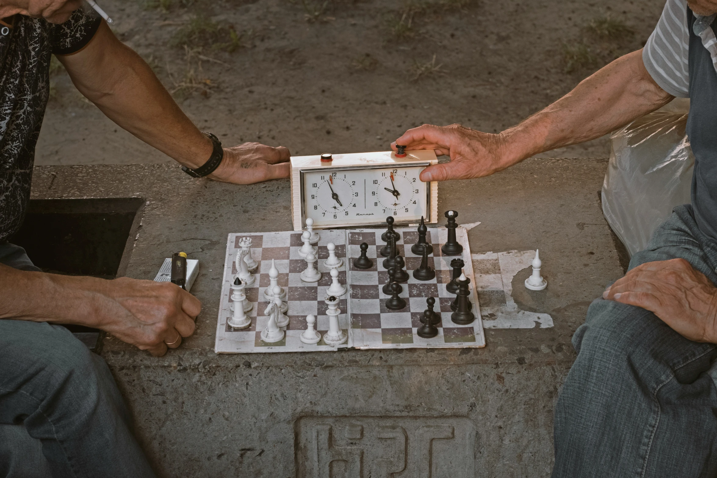 two men playing checkers on a street corner