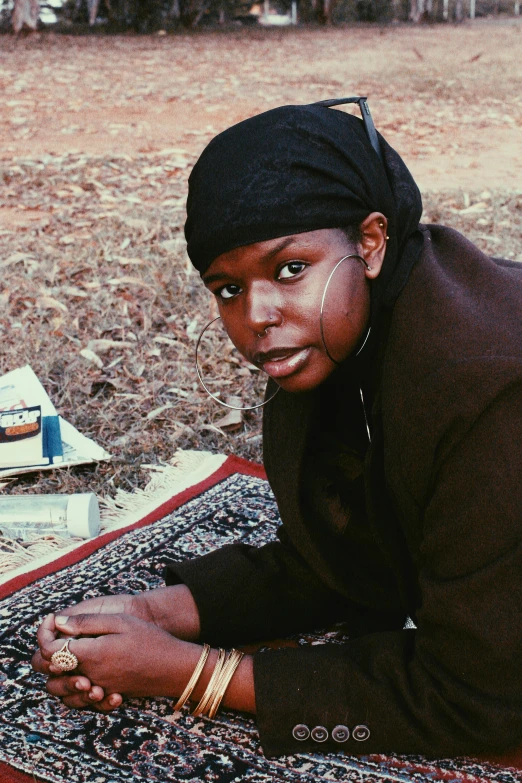 a black female laying on top of a rug