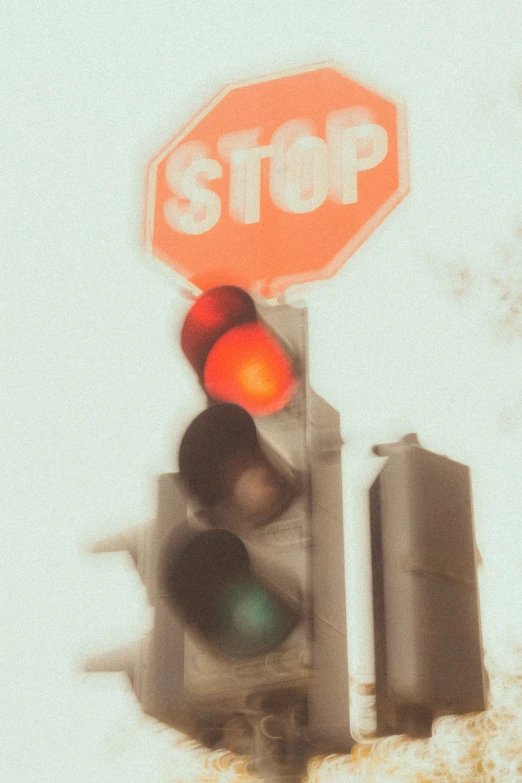a street light has a stop sign above it