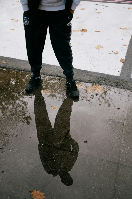 a man that is standing on a sidewalk