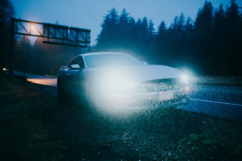 some cars parked at night on the side of the road