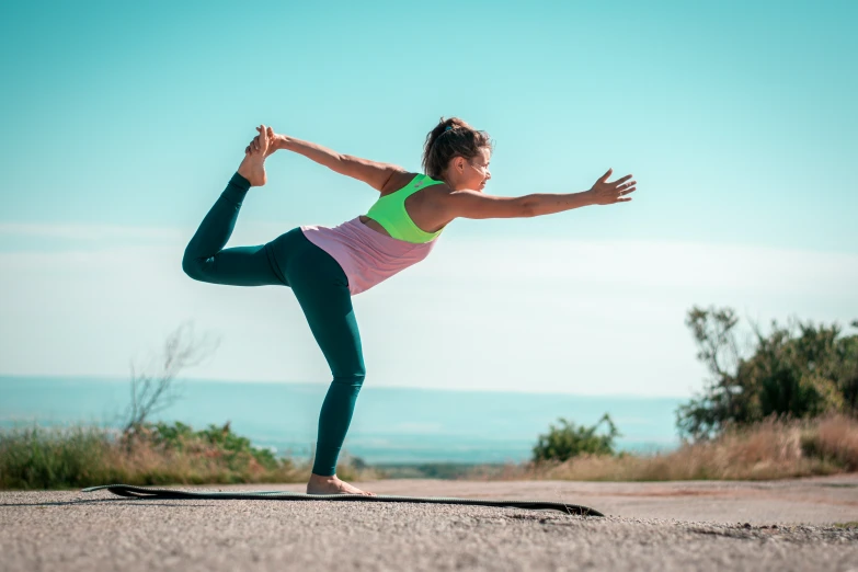 a woman is doing a yoga pose on a skateboard