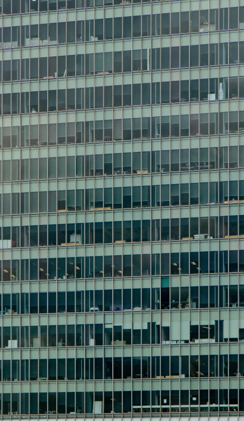 glass building with a clock on the side of it