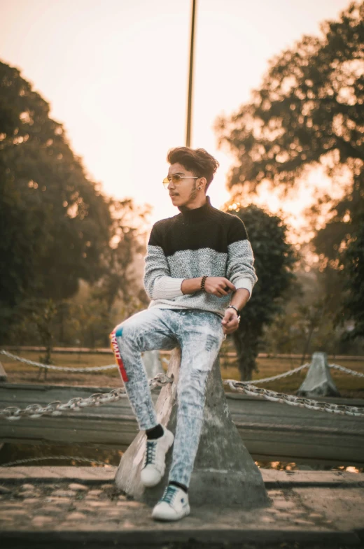 a man sitting on a wooden bench in a park