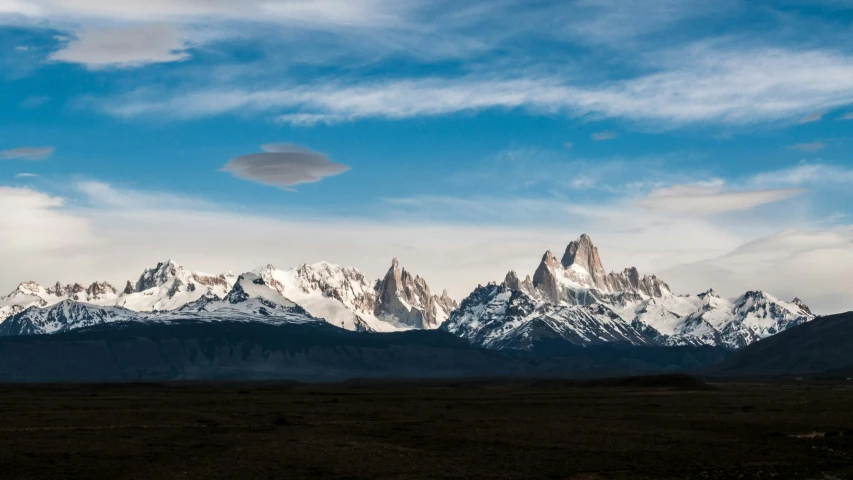 the mountains in the distance are seen against a blue sky