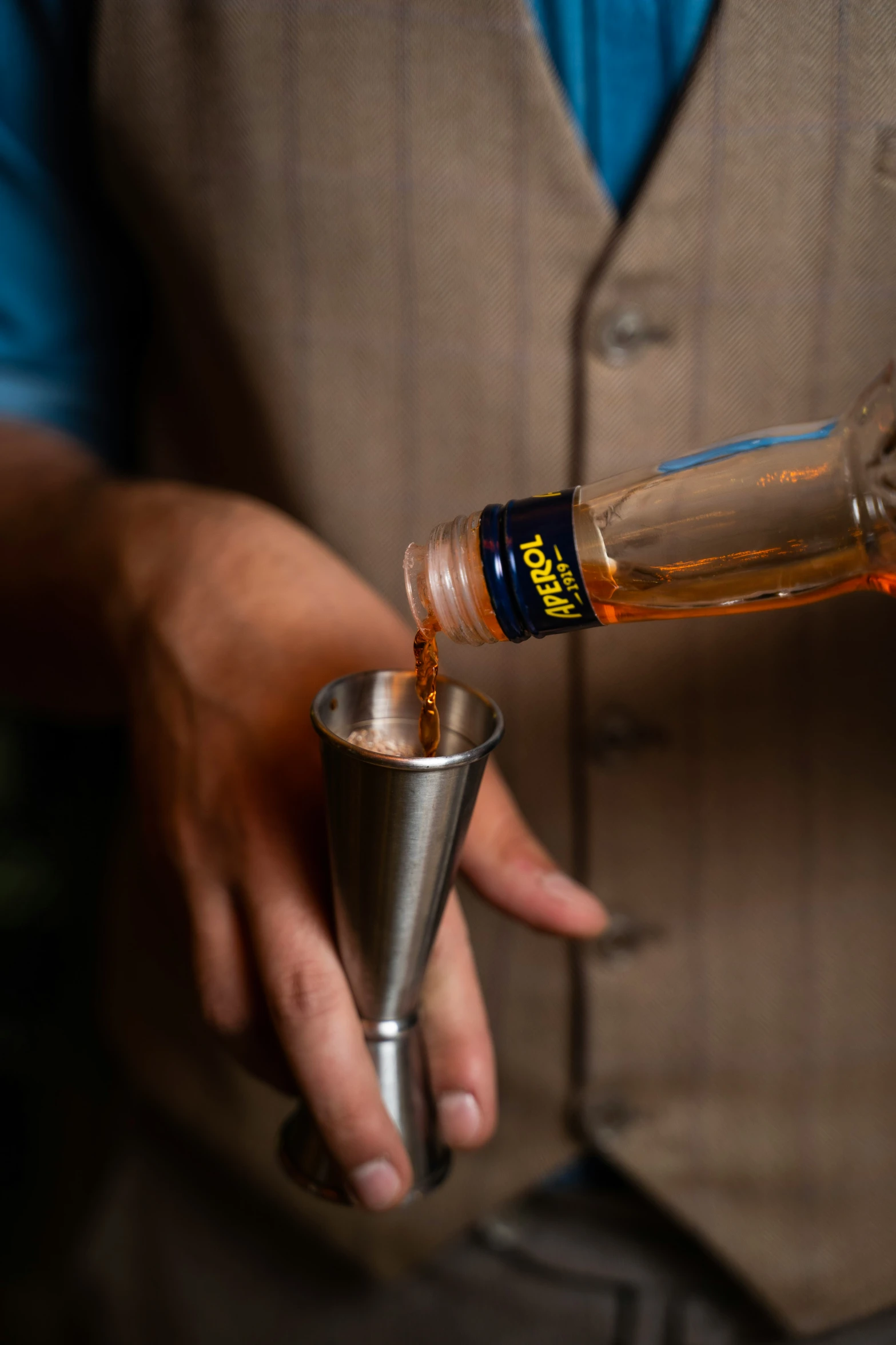 bartender pouring beer into glass with man behind