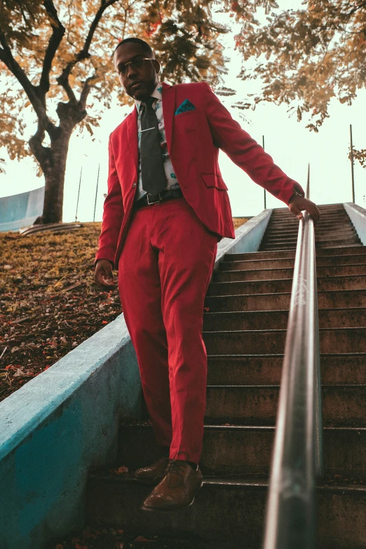 a man in a suit leaning on the steps