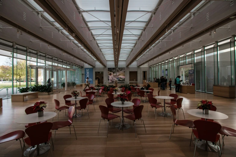 there is room with tables and chairs set up for breakfast