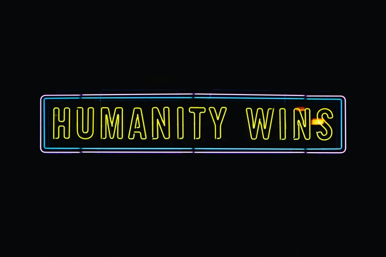 neon text that reads humanity win on a black background