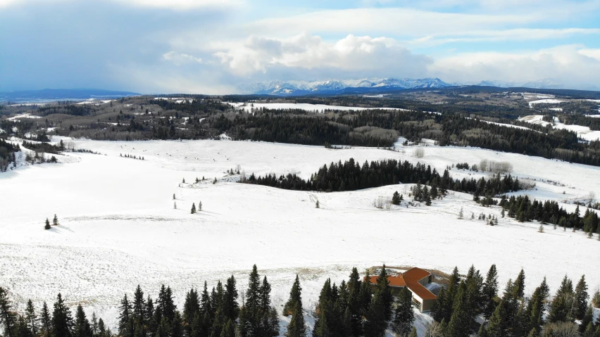 view of the mountains from the top of a snowy hill