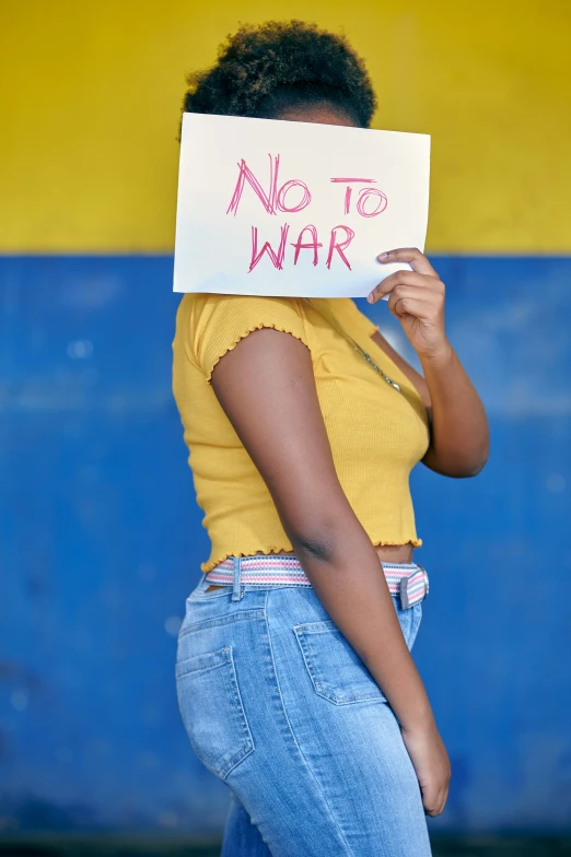 a woman with a sign that reads, no to war