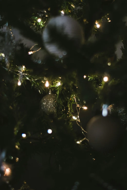 closeup of ornaments and christmas tree lights