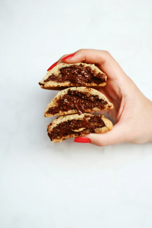 a woman is holding a pastry and posing for a picture